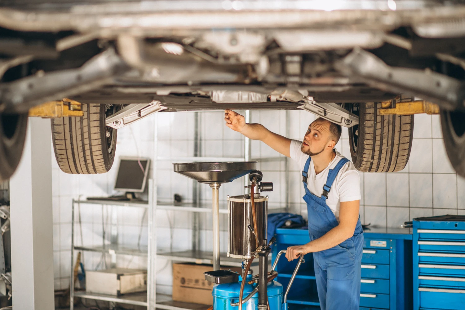 ASE-certified technician performing vehicle maintenance at Bill Tyson's Auto Repair in Delray Beach, Florida.
