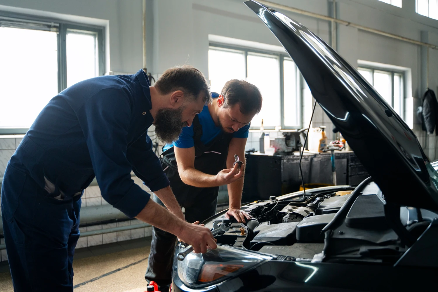 Automotive technicians working together in the Bill Tyson's Auto Repair West Boca Raton service center.
